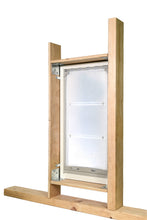 A pet door is framed with unfinished lumber.