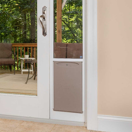 A white patio door with a dog door installed.