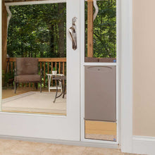 A patio door with a dog door installed leads to an outdoor deck.