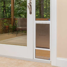 A sliding glass door with a PetSafe pet door insert.