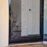 A close-up of a black-framed screen door.