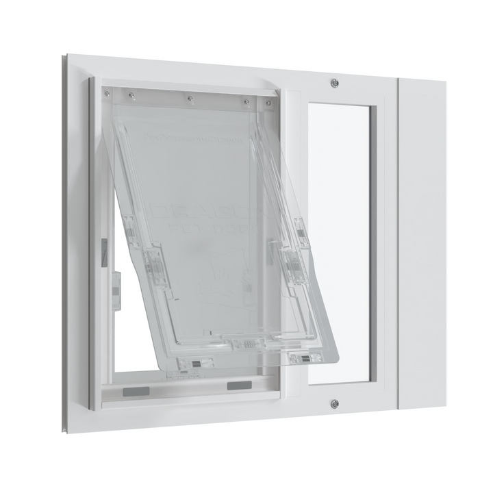 A white Dragon Vinyl Pet Door for Sash Windows installed in a window with the flap open and the top-loading locking cover in place.