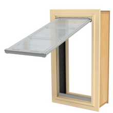 A pet door with a hinged, transparent flap is installed in a wood frame.