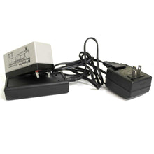 The image shows a SigmasTek maintenance-free sealed lead-acid battery connected to a black charger with a black cord, along with a separate black wall plug charger.