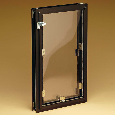 A pet door with a tinted flap is mounted in a frame.