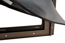 A brown-framed opening is partially covered by a black flap.