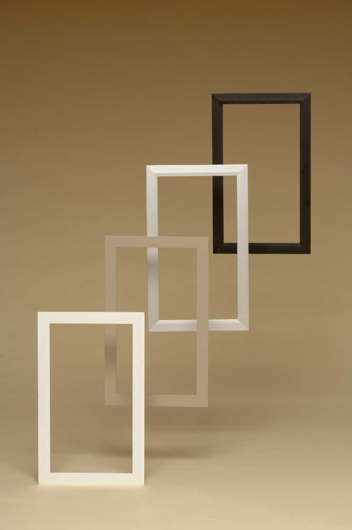Four empty rectangular frames, ranging from white to black, arranged in a diagonal line on a neutral background.