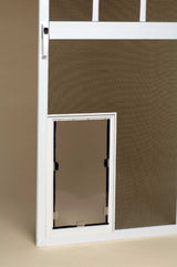 A white screen door with a pet door.