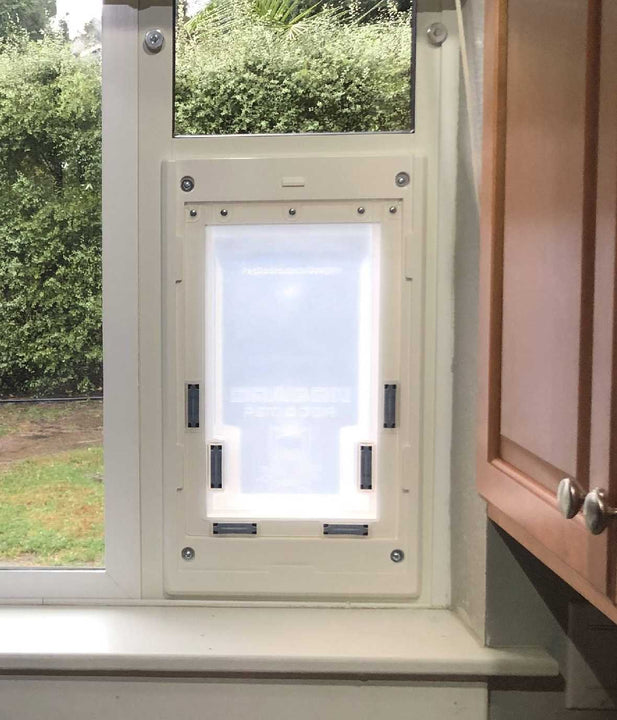  Dragon small single flap pet door for windows, white, installed in sliding window.