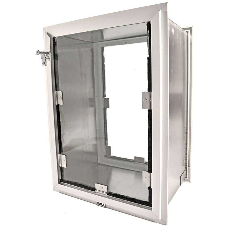 A silver-framed pet door with a clear flap and a locking mechanism is shown at an angle against a white background.