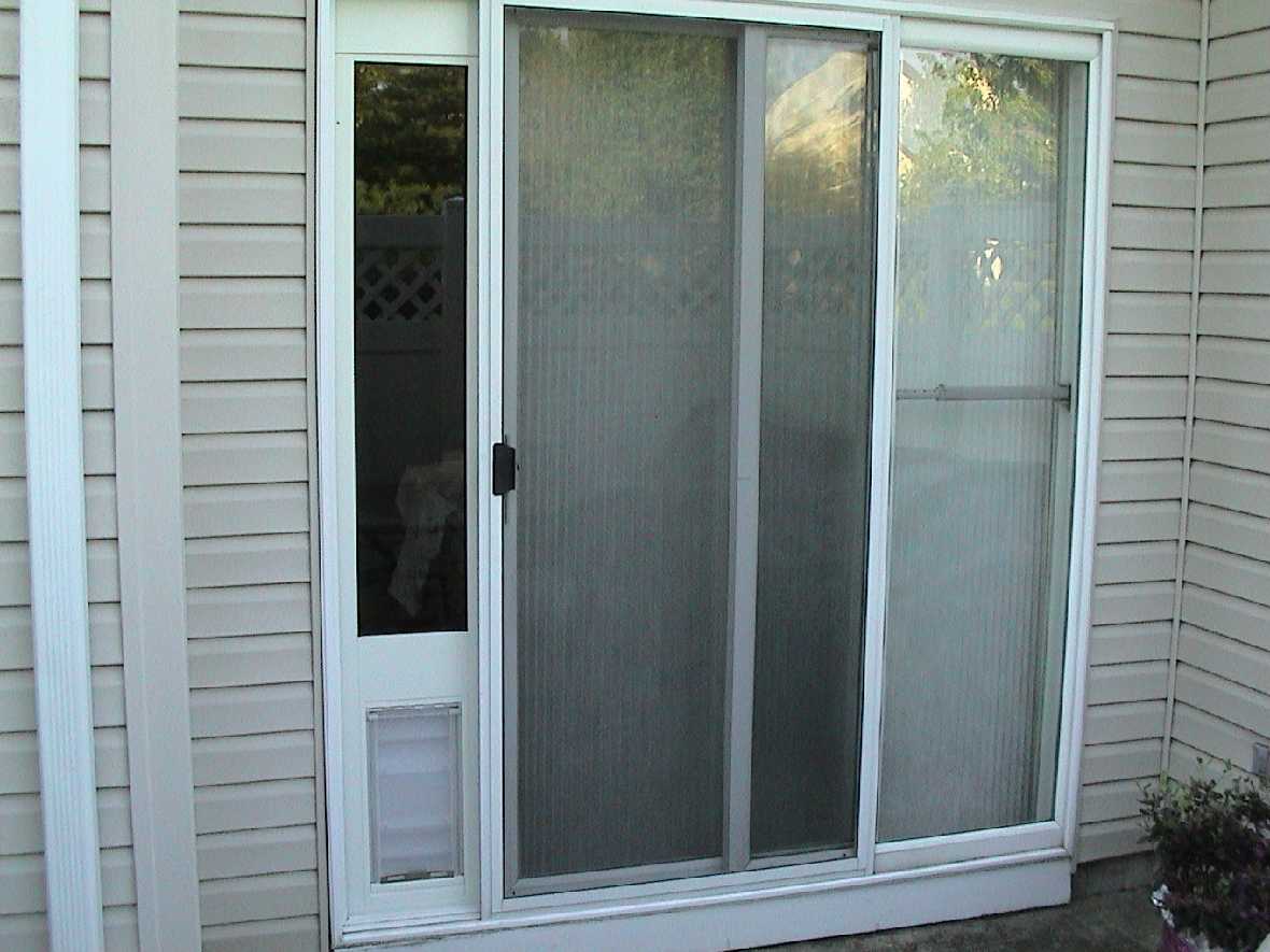 Exterior view of a sliding glass door with a built-in pet door.