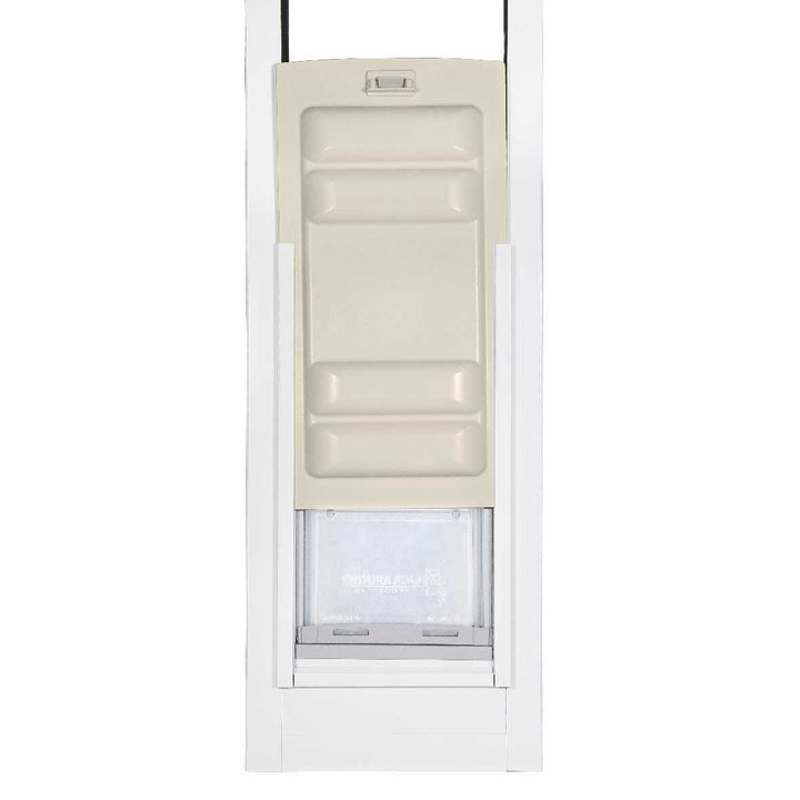 A dog door installed in a white frame.