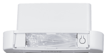 A white PetSafe device with screws and hardware in a plastic bag visible in a compartment.