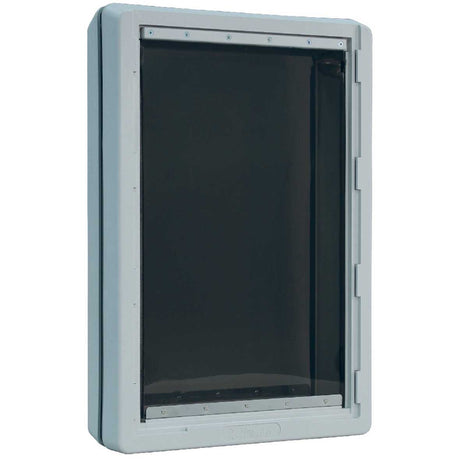 A gray pet door with a black flap.