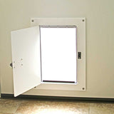 A pet door with a white frame and open flap is installed in a wall.